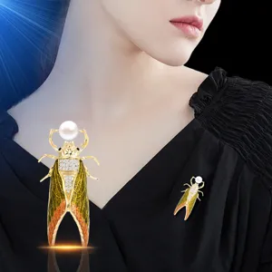 Elegant gold cicada brooch featuring a freshwater pearl and sparkling rhinestones for women.