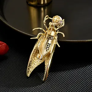 Elegant gold cicada brooch featuring pearl accent, perfect statement jewelry for women's outfits.