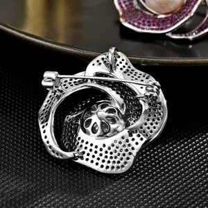 Silver tone camellia flower brooch back view with secure pin clasp accessory detail.