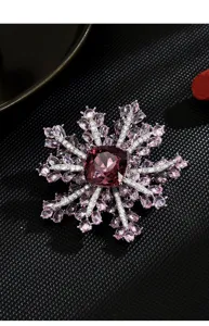 Exquisite double layer snowflake brooch featuring stunning pink crystal and sparkling stones.