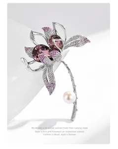 Close-up detail of elegant crystal flower brooch with purple stones and pearl stem accent.