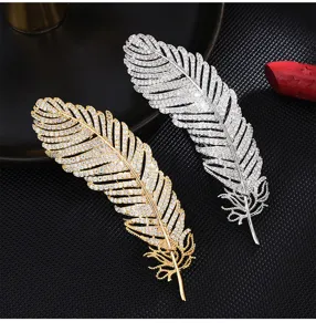 Luxury rhinestone feather brooch pin set, elegant metallic suit accessory for women and men.