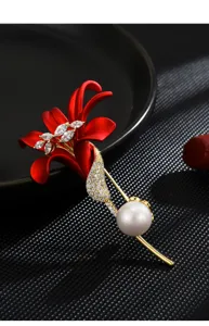 Exquisite red lily flower brooch with sparkling cubic zirconia and elegant pearl for women.