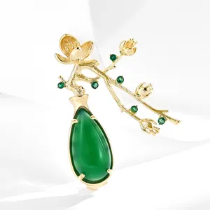 Elegant Chinese style plum blossom vase brooch with green chalcedony and gold.