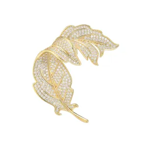 Elegant gold leaf brooch with dazzling pavé stones, perfect for chic coats and suits.