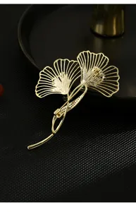 Elegant gold-tone ginkgo leaf brooch pin, sophisticated botanical jewelry accessory for women.