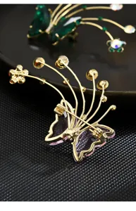 Exquisite crystal butterfly brooch detailed view, elegant zircon suit jacket accessory.