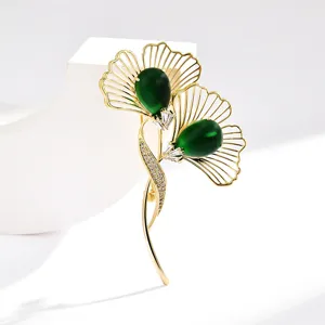 Elegant ginkgo leaf brooch with deep green stone and sparkling zircon for women's fashion.