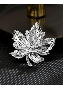 Silver maple leaf brooch detail view, showcasing the fine pin clasp and hollow back design.