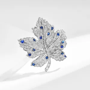 Luxury blue zircon maple leaf brooch pin for women, elegant rhinestone plant suit coat accessory.