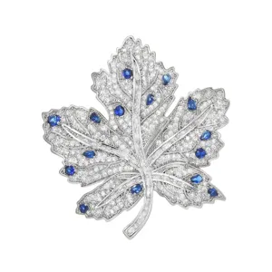Stunning blue zircon maple leaf brooch with sparkling pavé stones, elegant accessory.