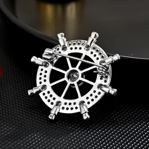 Elegant silver ship wheel brooch with sparkling zircon crystals for mens fashion suits.