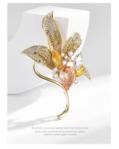 Luxury gold-tone leaf brooch adorned with sparkling multi-colored zircons & crystals.