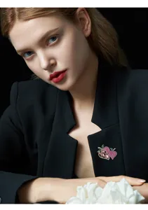 Close-up of exquisite double strawberry brooch with pink zirconia, elegant detail shot for women.