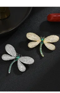 Close-up detail of exquisite crystal dragonfly brooch featuring sparkling pavé stones.