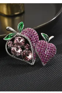 Exquisite double strawberry brooch detailed view, sparkling pink zirconia and green leaves.