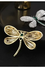 Dragonfly brooch detail shot showcasing exquisite crystal pavé and secure pin clasp design.