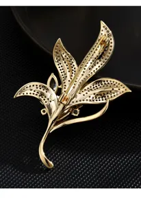 Detailed view of gold-toned leaf brooch back structure, exquisite craft for women accessories.