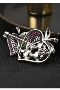 Detailed view of exquisite double strawberry brooch back featuring secure pin and pink zirconia.