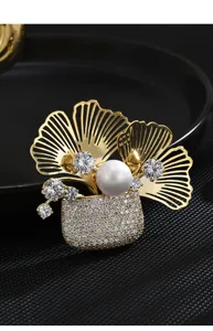 Close-up detail of the luxury gold plated ginkgo leaf flower basket brooch with sparkling zircons.
