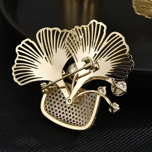 Elegant ginkgo leaf flower basket brooch, premium copper gold-plated micro-inlaid zirconia.