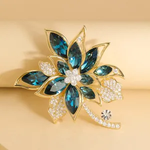 Elegant rhinestone flower brooch with deep blue crystals and gold-tone finish for women.