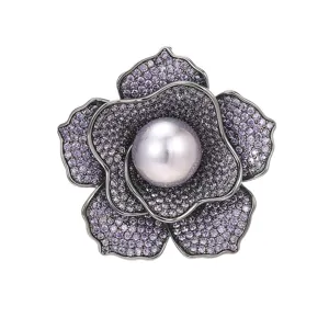 Elegant purple zircon flower brooch with central gray pearl, luxury fashion accessory.