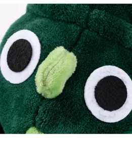 Close up detail of green flannel pet dinosaur costume with cute plush eyes and nose features.