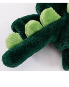 Detailed close-up of green fleece pet dinosaur outfit highlighting soft texture and dorsal spikes.