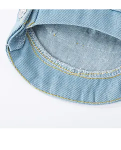 Denim pet clothing close-up, showing neat yellow stitching and durable fabric details.