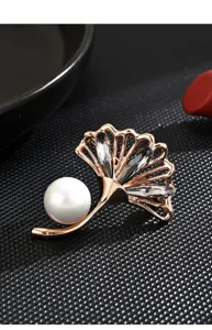 Elegant ginkgo leaf brooch featuring a pearl and sparkling crystals for women detail shot