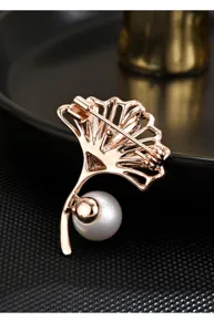 Exquisite detail of rose gold ginkgo leaf brooch featuring elegant pearl coat accessory pin.