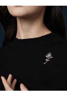 Exquisite blue crystal rose brooch featuring a polished rose gold tone stem for women.