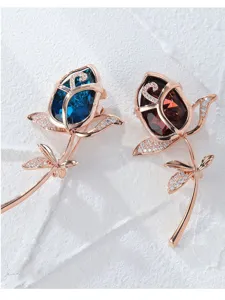Detail shot of exquisite rose crystal brooches with sparkling rhinestone leaves in elegant design.