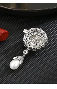 Back view showing pin mechanism and exquisite filigree details of the vintage pearl brooch.