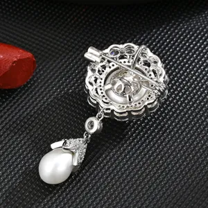 Vintage court style freshwater pearl brooch with sparkling zircon, elegant metal back pin design.
