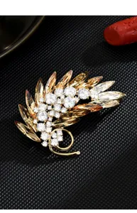 Crystal feather brooch detailed view, luxury rhinestone leaf corsage pin for women suits.