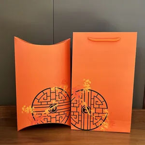 Orange gift box set detail showing pillow box and paper bag with elegant oriental print.