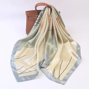 Detailed view of luxurious satin square scarf with elegant botanical line print draped gracefully.