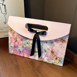 Floral envelope gift box featuring a black ribbon bow for elegant scarf and shawl packaging.