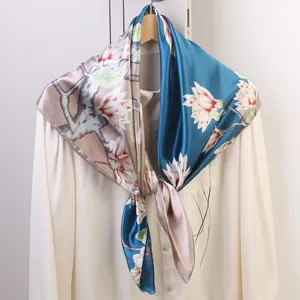 Close-up detail of the 90cm silk square scarf featuring elegant magnolia floral print design.