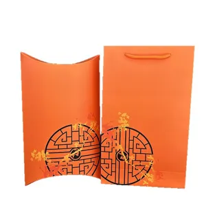 Orange paper gift bag and pillow box set with classic Chinese round lattice print.