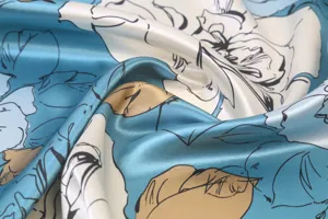 Close-up detail of smooth imitation silk fabric featuring elegant blue and white rose floral print.