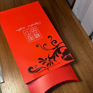 Red Chinese style gift box and bag detail, elegant packaging for scarf presentation.