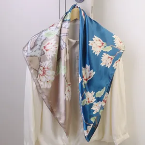 Detailed view of 90cm floral print silk square scarf with elegant magnolia tree branches.