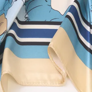 Close-up detail of smooth silky square scarf featuring elegant blue striped and beige borders.