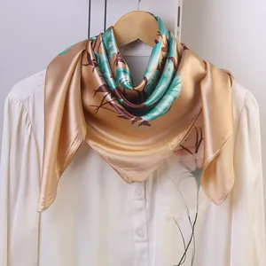 Detailed view of the silk floral square scarf showcasing elegant satin texture and vibrant print.
