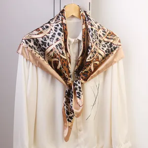 Detail view of the luxurious leopard print square scarf featuring elegant chain motifs.