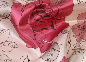 Close-up of smooth imitation silk scarf featuring elegant large rose floral print texture.