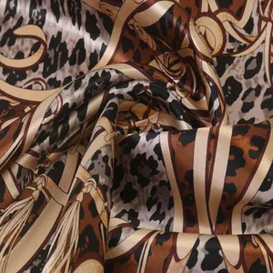 Detailed view of the luxury leopard and baroque chain print silk square scarf texture.